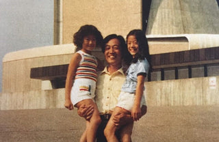 childhood photo of Angela with her dad and sister