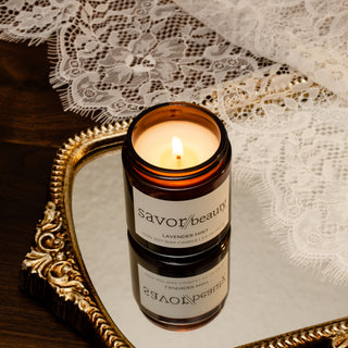 Savor Beauty Candle in a glass jar on a decorative tray with lace background