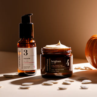 Two skincare products, a bottle and a jar, on a neutral background with a warm light.