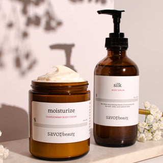 Two skincare products from savor beauty on a light surface with a blurred background