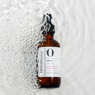 Kalahari cleansing oil in water with bubbles around it.