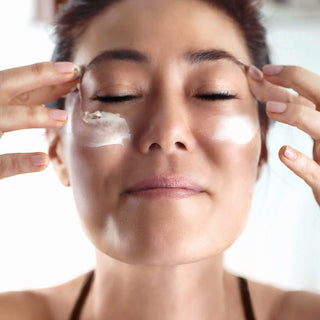 Korean woman putting on Truffle Face Cream for skin radiance