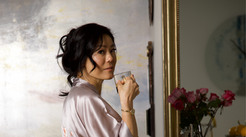 a woman in a robe drinking tea