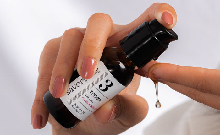 Close up shot of pumping Pumpkin Seed Serum on hands