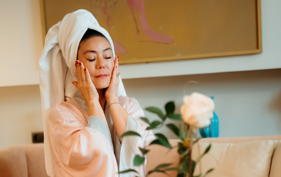 woman patting her face dry