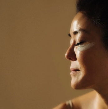 woman with face cream on her upper cheek