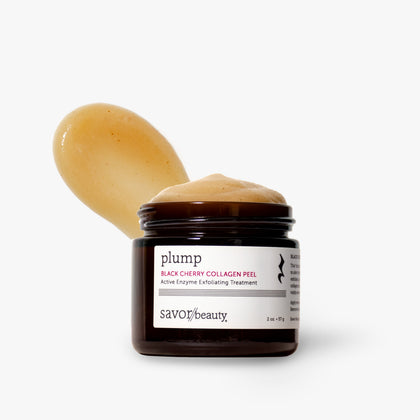 A jar of Savor Beauty Plump Black Cherry Collagen Peel with a scoop of the peach-colored cream product resting behind it, set against a clean white background.