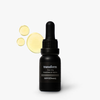 A black dropper bottle labeled 'transform' by Savor Beauty, shown on a light gray background with three pale yellow circular droplets floating to the left.