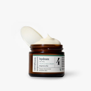 Fragrance-free Truffle Face Cream jar open with whipped face cream over the top on plain background