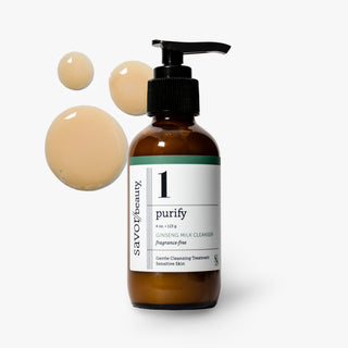 A bottle of savor beauty purify Ginseng Milk Cleanser with a black pump dispenser and a white label, shown on a light gray background with three beige liquid droplets floating to the left.