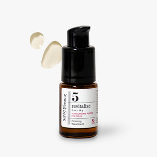 Savoir Beauty 5 Revitalize Pomegranate Peptide Eye Serum in amber glass bottle with a black pump dispenser, shown on a light gray background with two droplets of serum floating to the left.