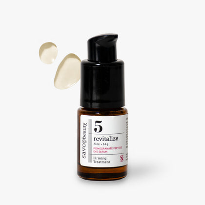 Savoir Beauty 5 Revitalize Pomegranate Peptide Eye Serum in amber glass bottle with a black pump dispenser, shown on a light gray background with two droplets of serum floating to the left.