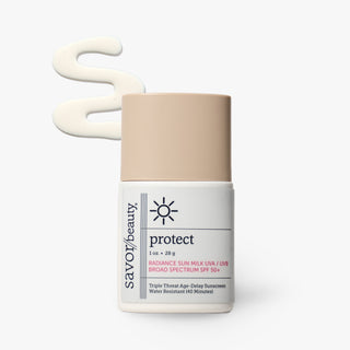 Savor Beauty Protect Radiance Sun Milk SPF 50+ sunscreen bottle with a beige cap and white label, shown on a light gray background with a beige cream swatch above it.