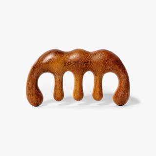 Wooden scalp gua sha on a white background