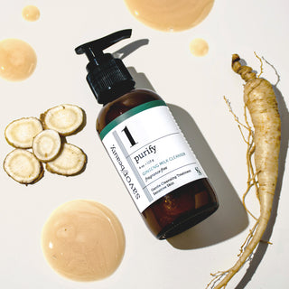 Brown bottle labeled 'purify' with a green label, surrounded by sliced roots and a ginseng on a light background.