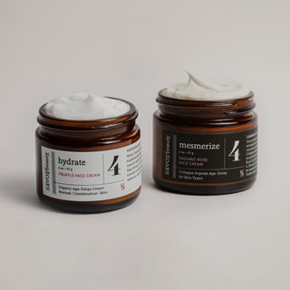Two jars of face cream with numbered labels on a neutral background
