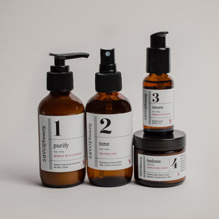 Set of four skincare products with numbered labels on a neutral background