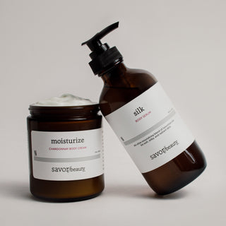 Two brown skincare bottles with white labels on a light gray background
