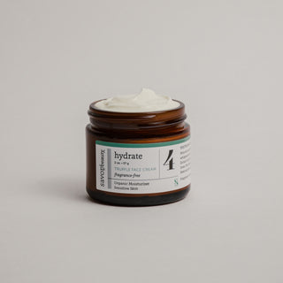 Fragrance-free Truffle Face Cream jar open with whipped face cream over the top on plain background