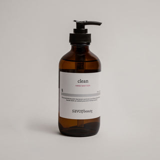 Brown bottle with pump and white label on a light gray background