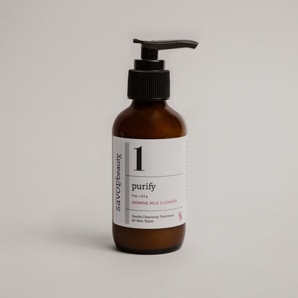 Brown bottle with pump and white label on a light gray background