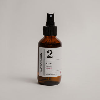 Brown spray bottle labeled '2' on a light gray background