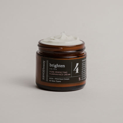 Open jar of face cream labeled 