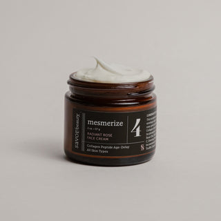 Open jar of face cream with black label that reads "mesmerize"