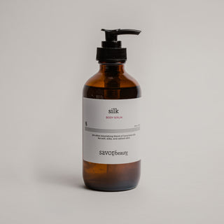 Brown bottle with pump and white label on a light gray background