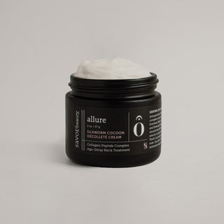 Jar of cream with 'allure' branding on a gray background