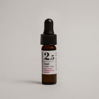 Small brown glass bottle with dropper labeled '2.5' on a light gray background