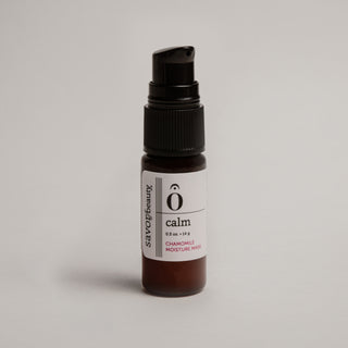 Skincare serum bottle labeled 'calm' on a light gray background