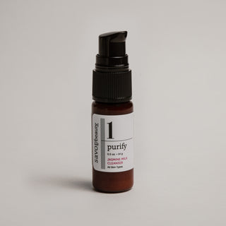 Travel size skincare serum bottle labeled 'purify' on a light gray background