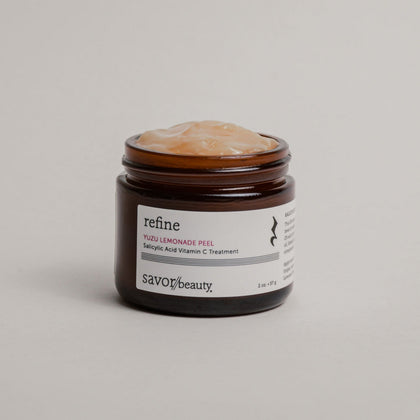 Open jar of face peel with while label reading 