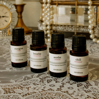 Set of savor beauty essential oils on a decorative tray with lace background