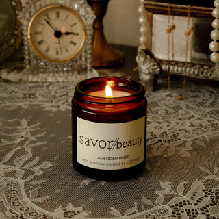 Savor Beauty Lavender Min soy candle on a decorative lace cloth vanity