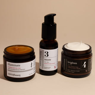 Three skincare products on a beige background