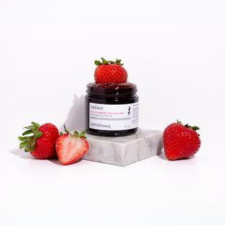 Jar of strawberry peel surrounded by fresh strawberries