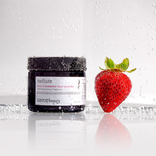 Strawberry face peel and fresh strawberry surrounded by bubbles
