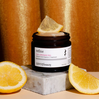 Yuzu Peel with lemon slices on a textured surface and gold curtain background