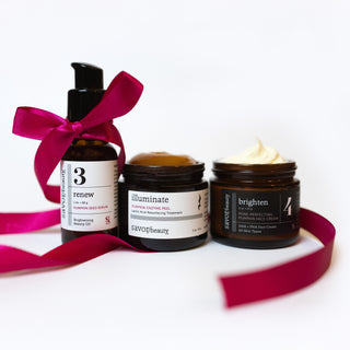 Three skincare products with labels '3 renew', 'illuminate', and 'brighten' on a white background with pink ribbons.