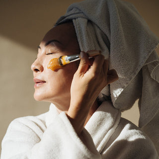 Woman applying Manuka Honey Mask: Exfoliating Treatment