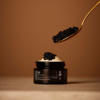 Black eye cream jar with caviar on a brown background