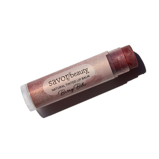 Berry Bite tinted lip balm laying against white background.
