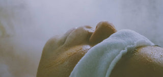 Close-up of a person's face getting a facial with a blurred background