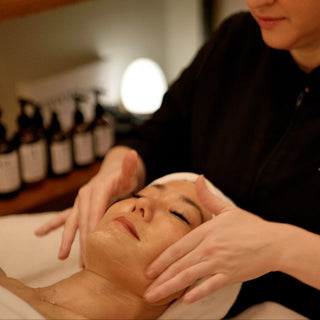 Woman getting a facial massage at spa
