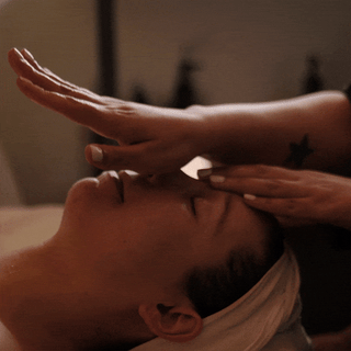 GIF of a relaxed spa guest receiving a facial massage 