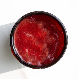 Overhead of strawberry peel's juicy red, jelly texture