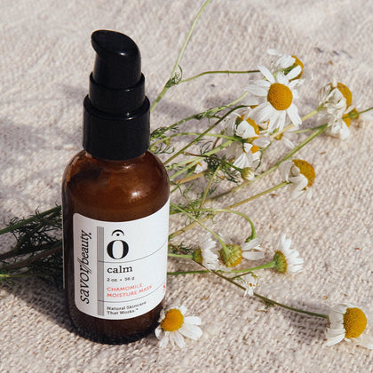 Chamomile Moisture Mask on a beige linen backround with fresh chamomile flowers 